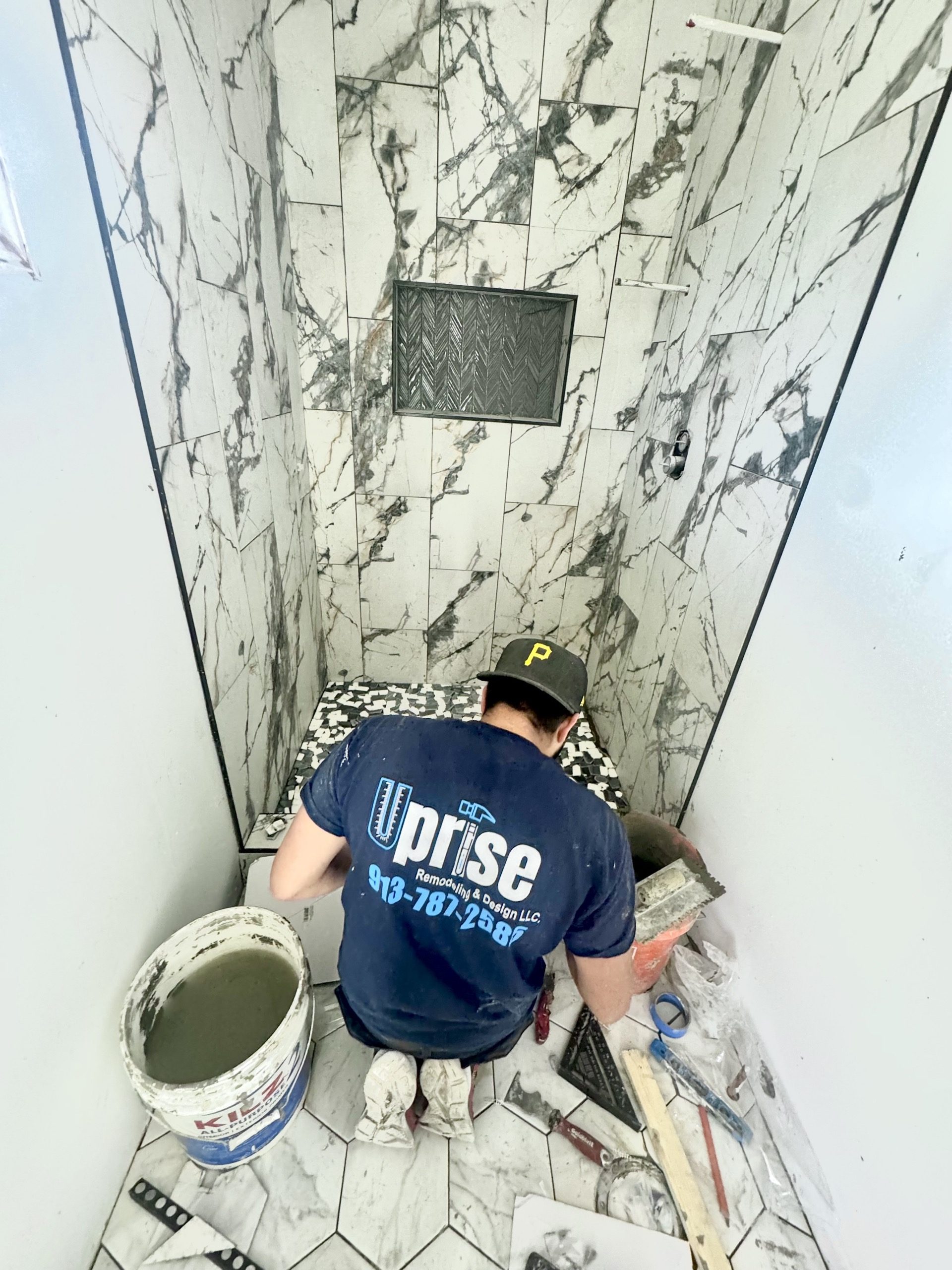 Uprise team member tiling a custom shower